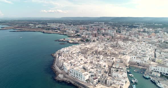 Aerial video. Old Town of Monopoli - city on Adriatic Sea. Province of Bari, region of Apulia. Italy