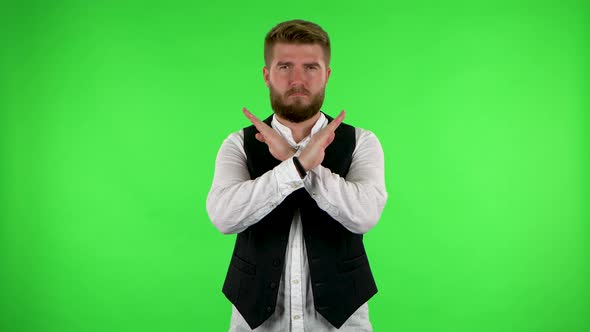 Man Strictly Gesturing with Hands Crossed Making X Shape Meaning Denial Saying NO. Green Screen alt