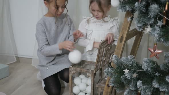 Happy American family celebrating Christmas. Children open a gift at home. alt