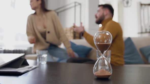 Woman Getting up From the Couch During Quarrel with Her Nervous Bearded Husband alt