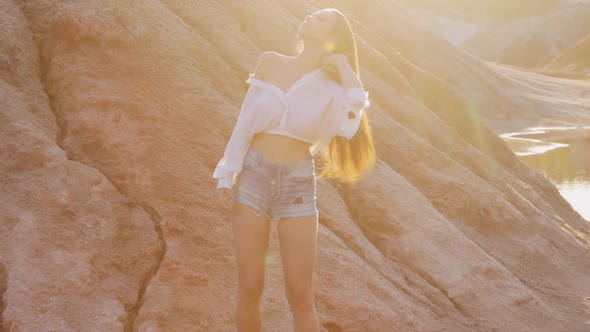 Beautiful woman posing on other-worldly hilly landscape