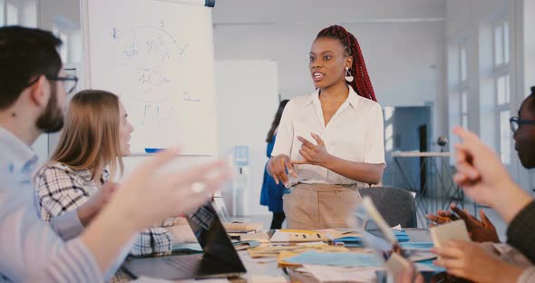 Teamwork at Healthy Workplace. Beautiful Young Black Female Team Leader Speaking To Happy Employees alt