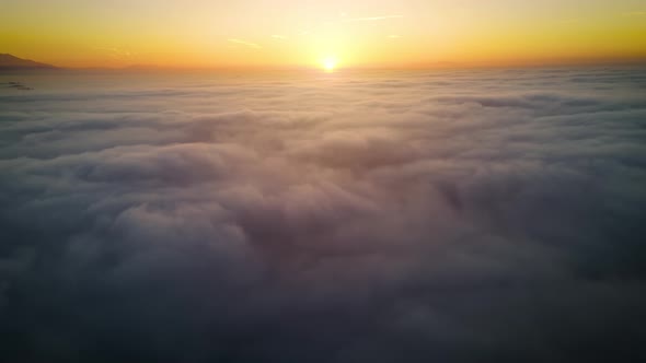 Aerial of the sunrise above the clouds alt