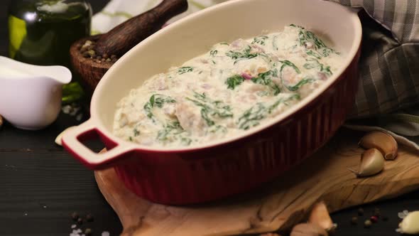 Delicious Small Meatballs with Spinach in a Creamy Sauce in Baking Dish alt