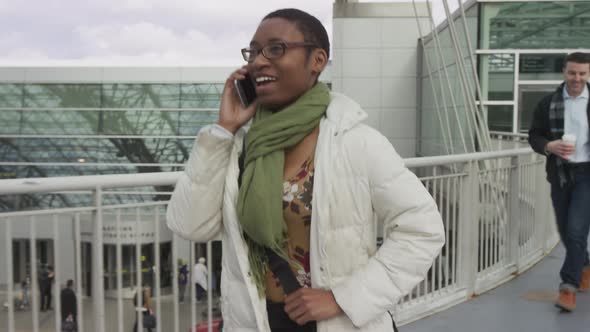 Businesswoman walking and talking at airport