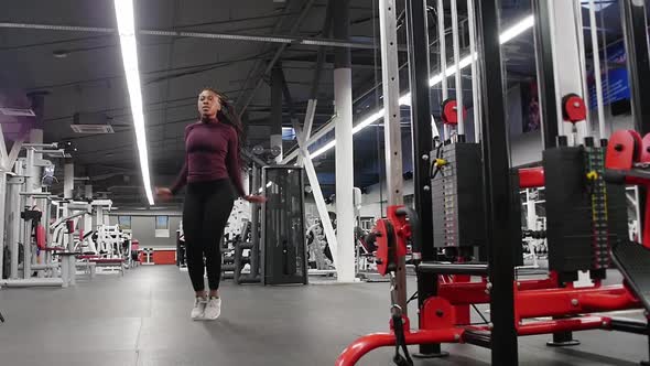 Sports Training  Black Woman Jumping on a Spot in the Modern Gym alt