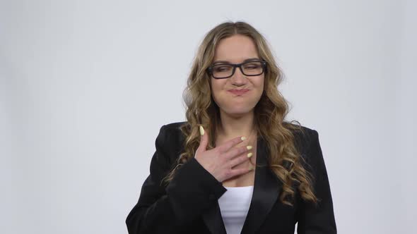 Woman Eagerly Eating Sweet White Marshmallow, Isolated on a Gray Background. alt