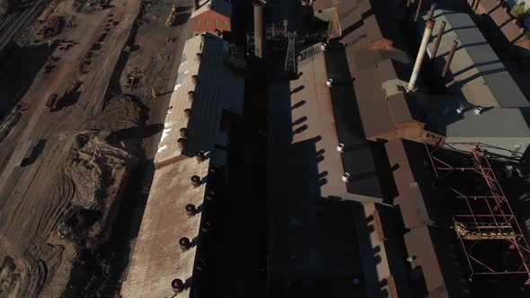 Eagle eye aerial view of rusty old steel mill about to be demolished alt