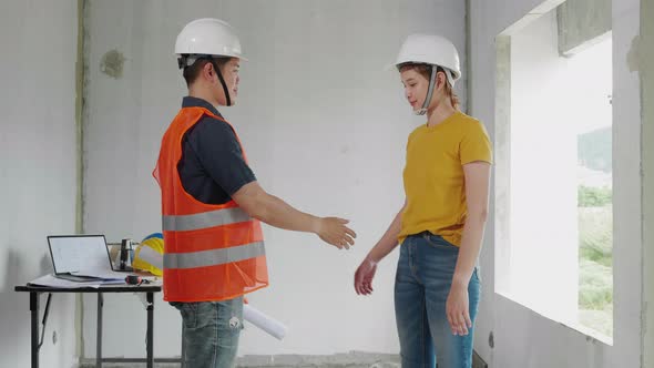 Construction engineer handshaking with the construction site owner to agree to join business work