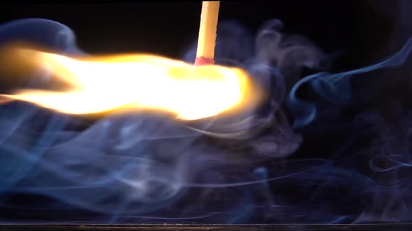 A Matchstick Lights After It Is Struck Against the Striking Surface of a Match Box. Slow Motion alt