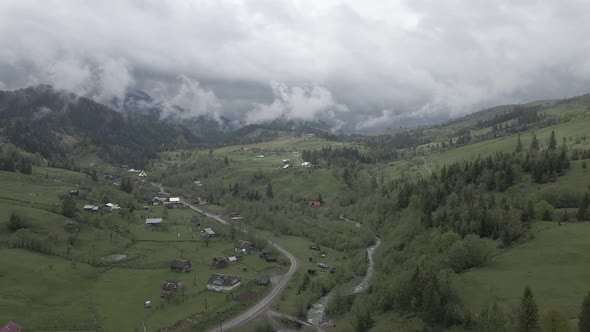Village in the Mountains. Slow Motion. Carpathians. Ukraine. Aerial. Gray, Flat alt