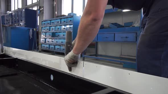 Man Twists the Screw With a Screwdriver. alt