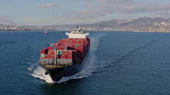 Ultra Large Loaded Container Ship Cruising in Open Ocean Aerial View alt