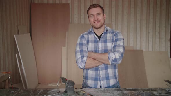 Portrait of a Young Carpenter Behind the Workplace