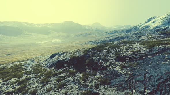 Beautiful Scenic Sunset View at Mountain Range and Dry Yellow Grass in Front alt