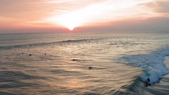 Aerial View of Surfer Riding Sunset Ocean Wave. Drone  Shot Surfing Ocean Lifestyle, Extreme Sports. alt