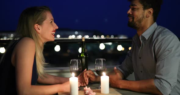 Young Beautiful Couple Having Romantic Dinner on Rooftop