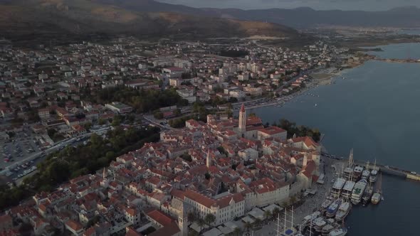 Aerial shot of Adriatic coast of Croatia, the old town of Trogir. Hills around the town, harbour