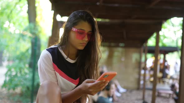 Beautiful Young Woman on Vacation in Pink Glasses alt