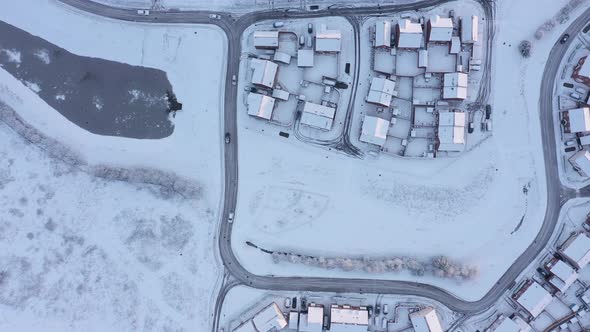 Aerial view of snow covered houses and roads in a residential area of the cit