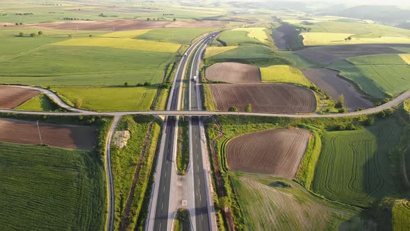 Highway with Traffic in Rural Scenery. Suburban Highway with Cars and Trucks. Travel and