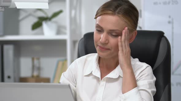 Exhausted Female Manager Massaging Temples, Suffering from Stress, Head Ache