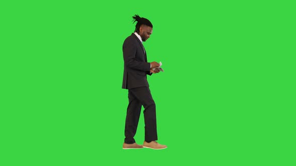 Black Man in Office Suit Walk Counting Money on a Green Screen Chroma Key alt