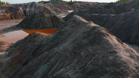 Aerial View of a Landscape Similar To the Planet Mars with Red Hills and Rivers with Red Water alt