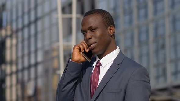 Charming Handsome Black Business Man Talking by Phone in The Street alt