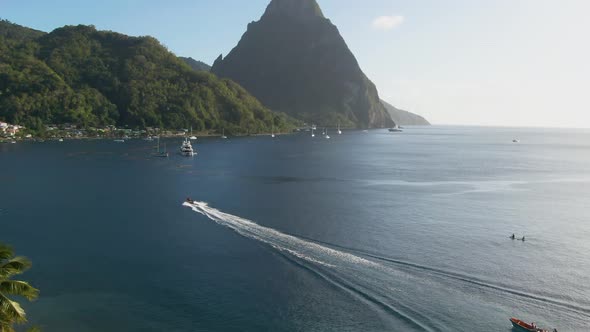 Sunny day drone-shot of mountain peaks and beach in the Caribbean alt