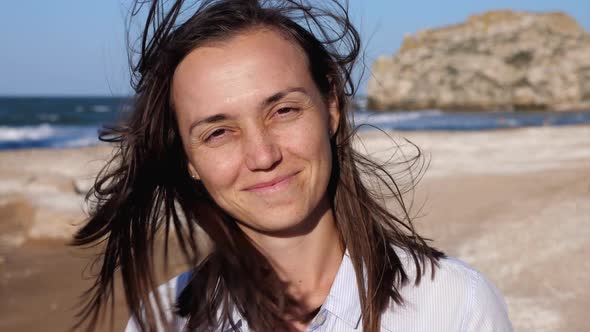Portrait of a Young Happy Woman at the Beach.