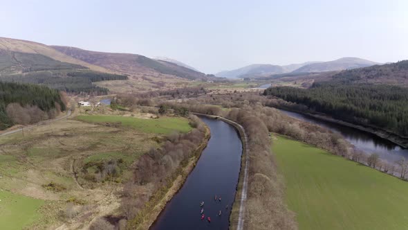 A Group of Canoeists Travelling Along a Canal in Scotland alt