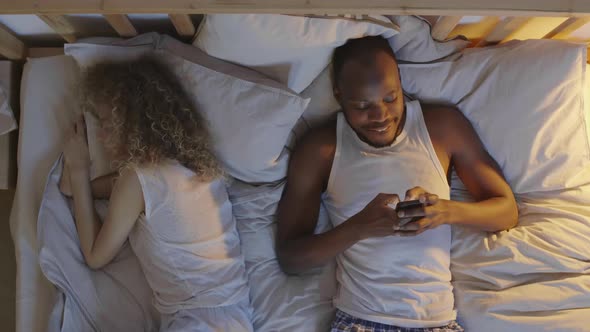 Woman Sleeping while Her Boyfriend Using Telephone alt