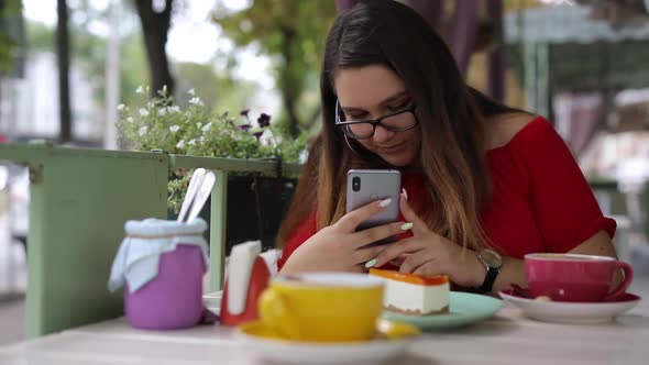 Woman Takes Pictures of Desserts in a Cafe and Examines Photos