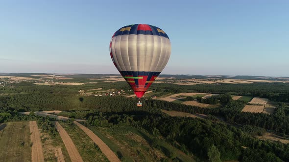 Aerial view of colorful hot air ballon flying in the sky in beautiful scenery