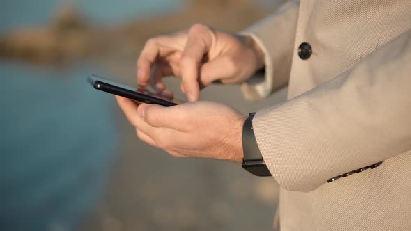 Man Looking At Cell Phone Using App And Browsing In Internet. Man Texting Mobile Phone. Messages. alt