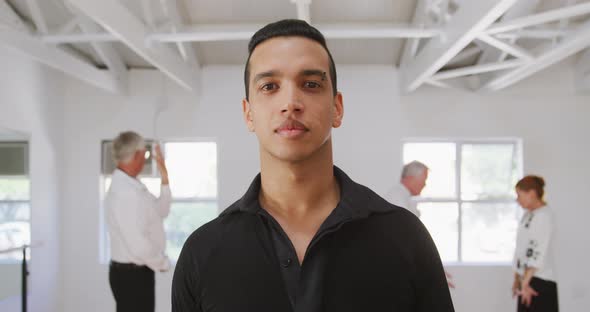 mixed race male dance teacher taking a ballroom dancing class at a dance studio alt