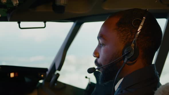 African American Copilot Taking Off with Airplane Captain alt