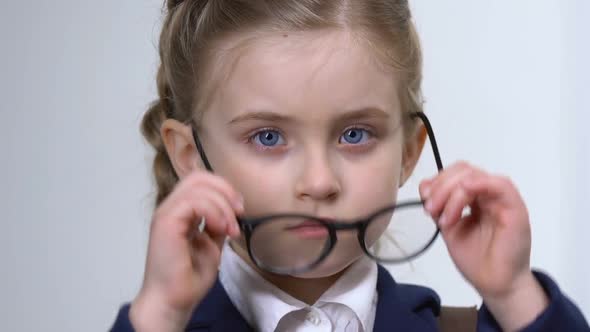 Sad Female Pupil Taking Off Eyeglasses, Little Schoolgirl Insecurities, Bullying alt