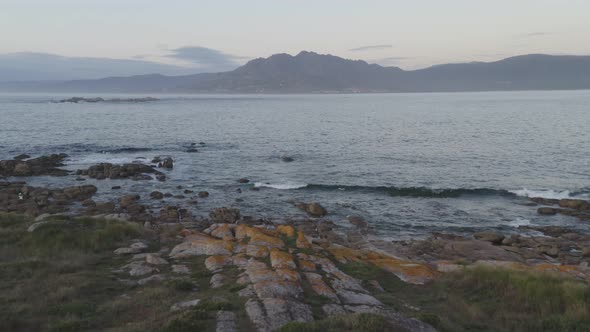 Amazing drone aerial landscape view of mountains in atlantic ocean with waves in Galiza, Spain alt