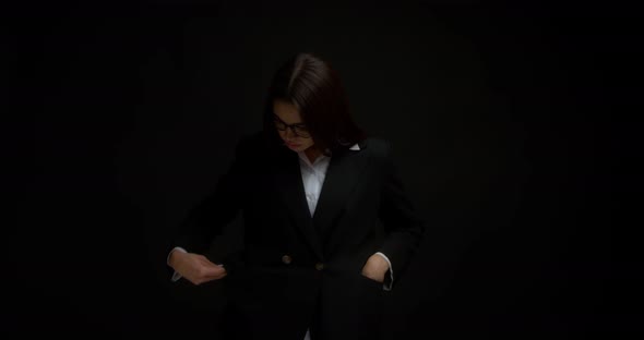 Business Woman with Glasses Showing Empty Pockets in a Jacket