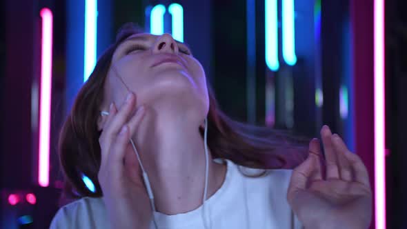 A Beautiful Young Woman Dancing in Headphones Face Closeup