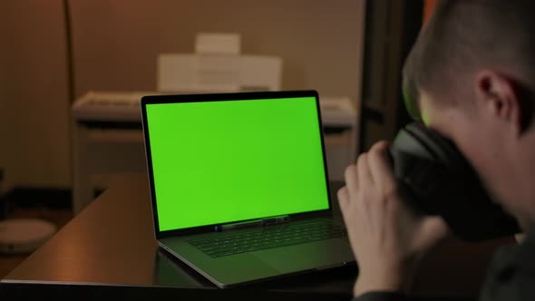 Man Engineer with VR Helmet Programming on Laptop with Green Screen alt