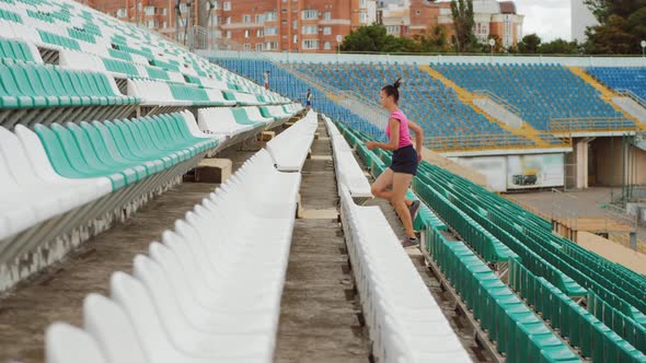 Side View of a Girl Running Upstairs at a Stadium alt