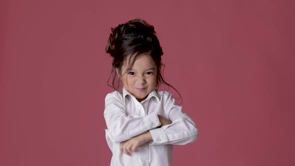 Cute Little Child Girl in White Shirt Shows Different Emotions on Pink Background.