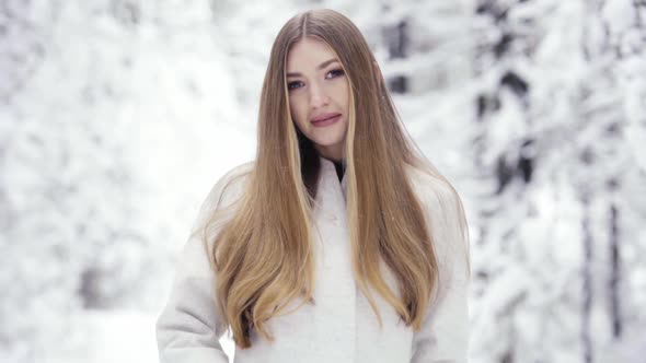 Beautiful woman in winter forest