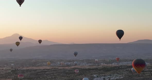 Aerial Cinematic Drone View of Colorful Hot Air Balloon Flying Over Cappadocia alt