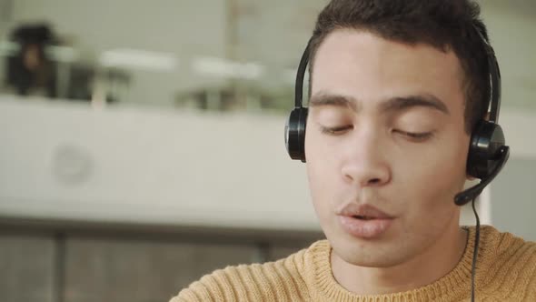 Close Up Smiling Handsome Latinos Man Communicates Via Video Link with a Headset on His Head, Mixed alt