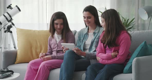 Mother and kids watching videos online together