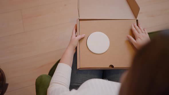 Selfemployed Woman Entrepreneur Packaging Product in a Box or Parcel for Delivery Over the Shoulder alt